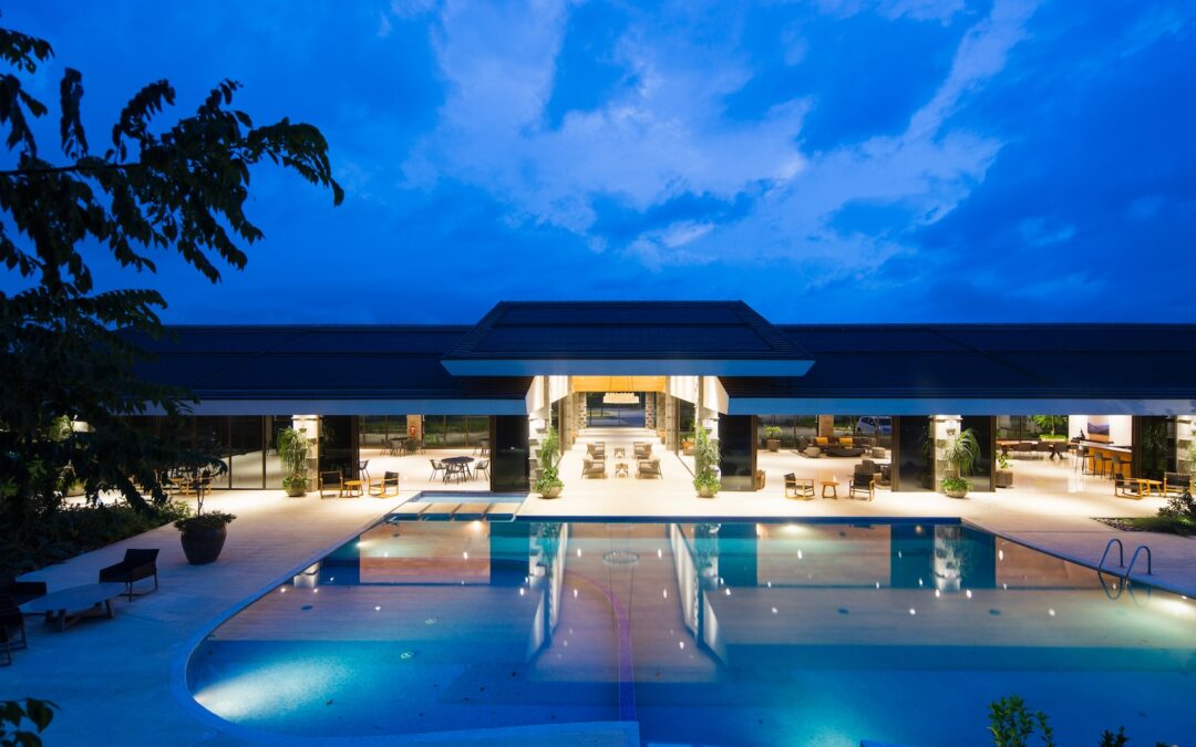 blue body of water in front of building near trees during nighttime