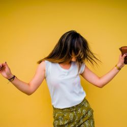woman standing near yellow wall